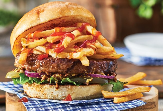 Hamburger with fries and ketchup on a checkered tablecloth