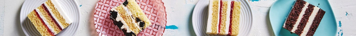 Slices of frozen cake on multi-coloured plates