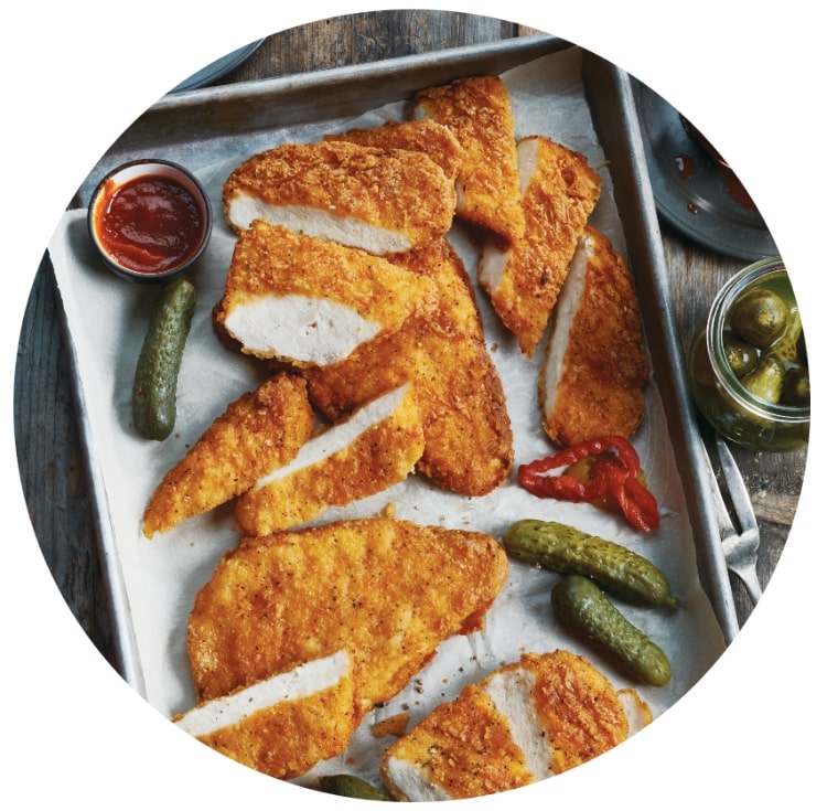Spicy Chicken Breasts on a tray with pickles
