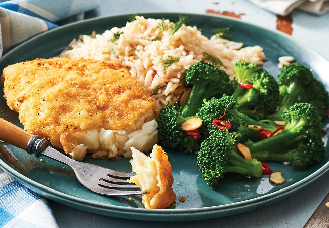 Seasoned breaded cod served with fresh veggies