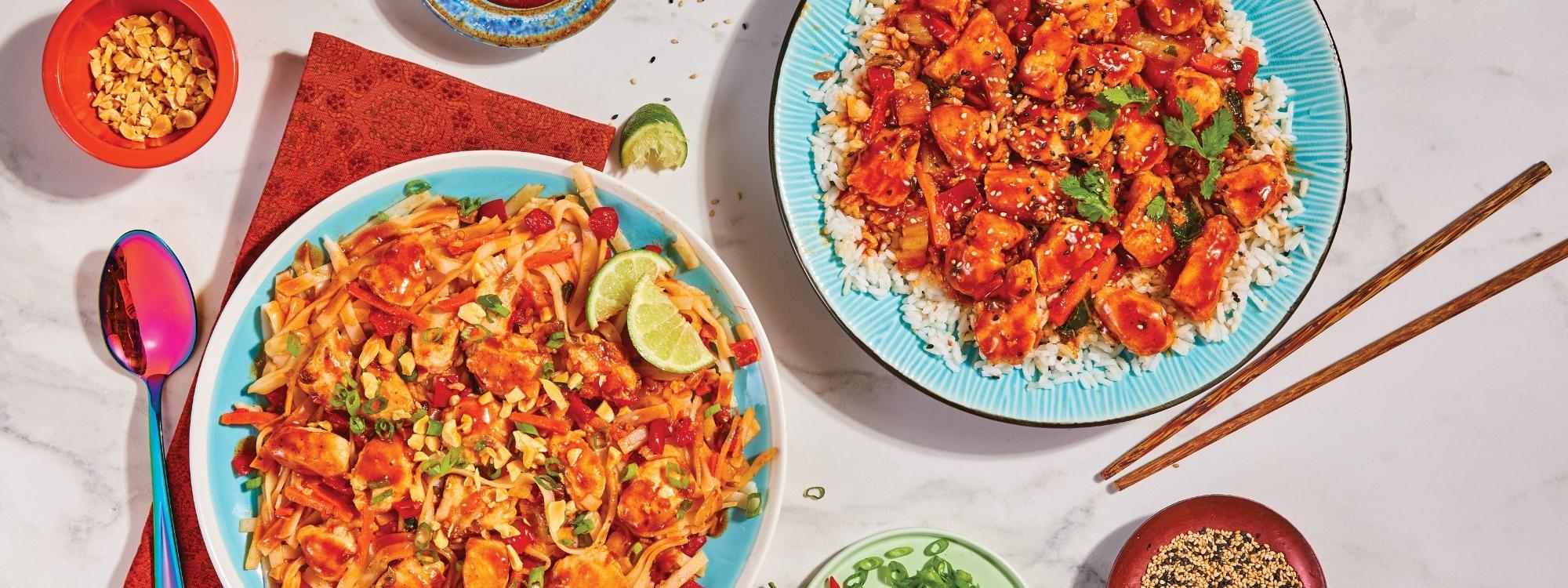 Two plates of colorful gluten free Asian-inspired frozen meals dishes with garnishes on a light surface