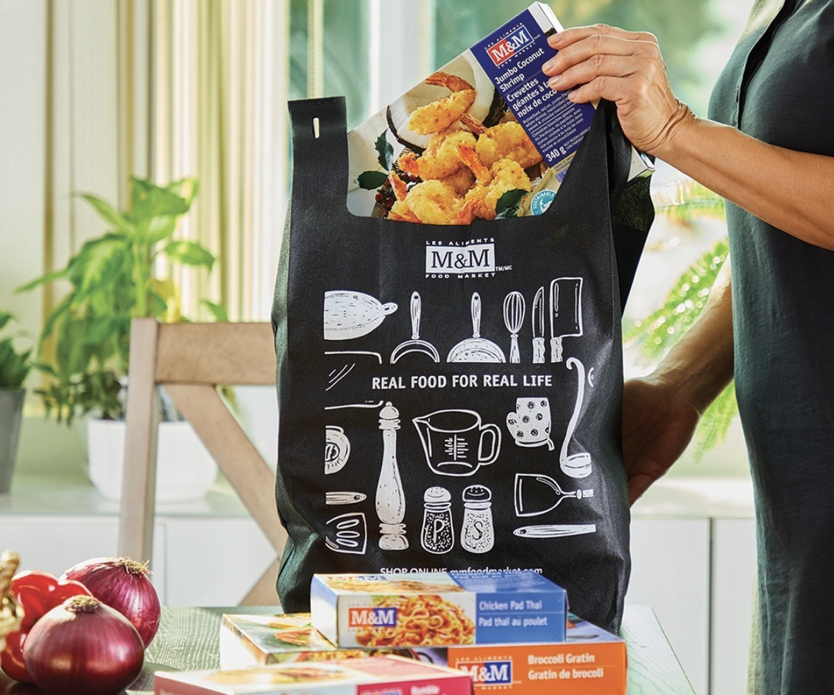 A shopping bag full of M&M Food Market frozen foods